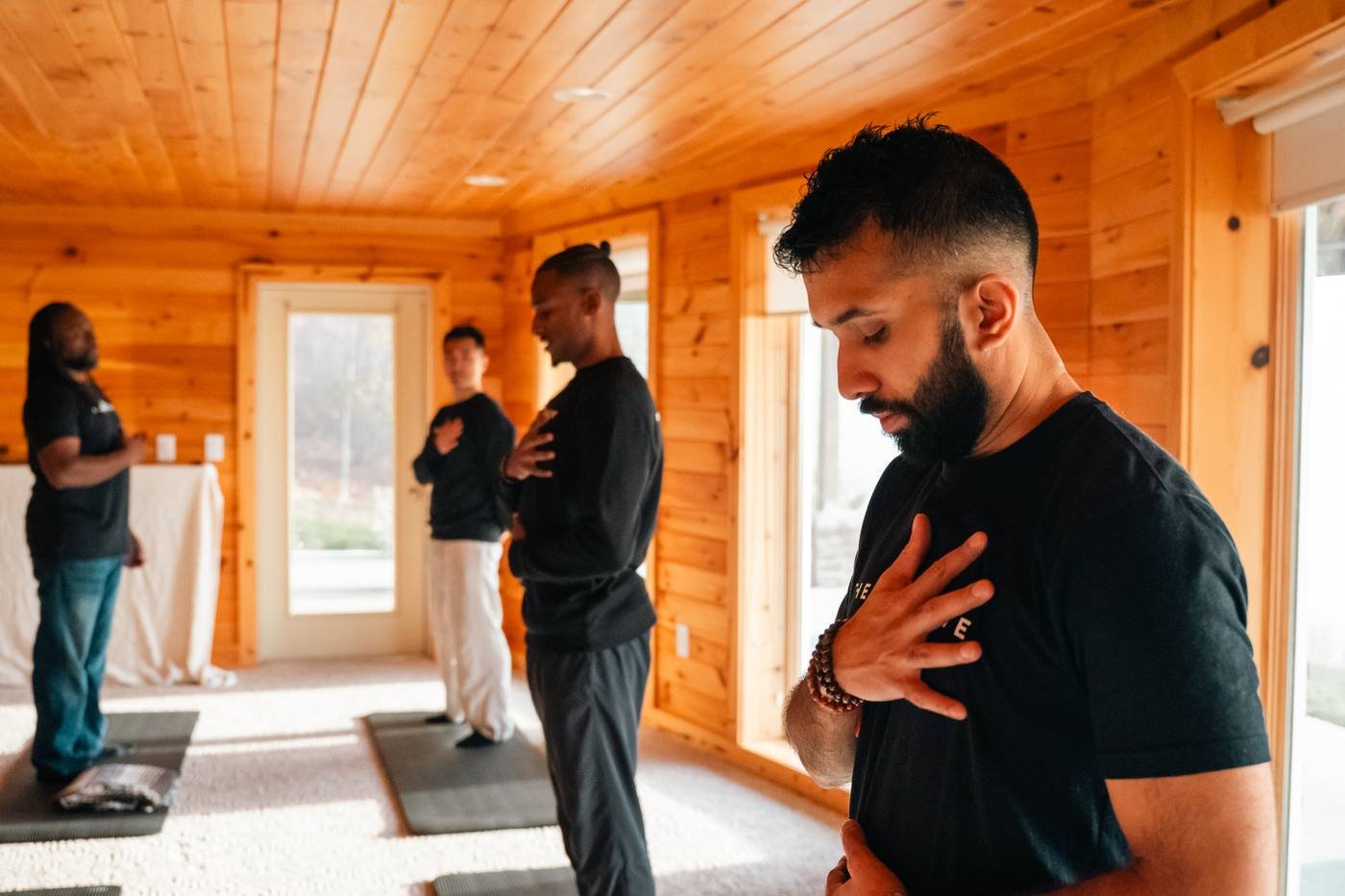 Men doing breathwork with hands on their chests