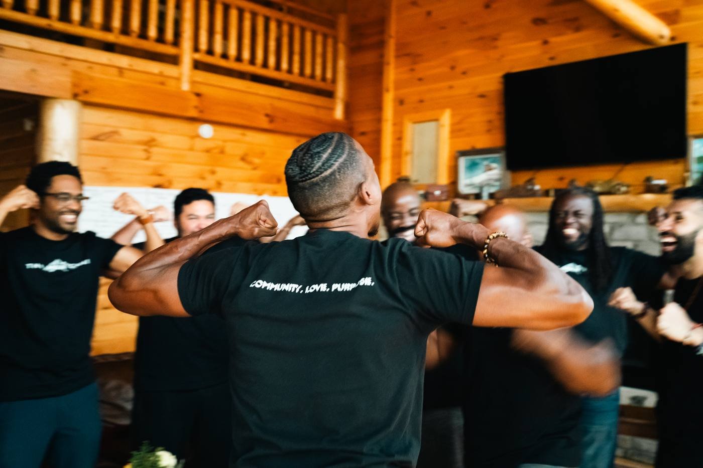 Men flexing and celebrating together indoors