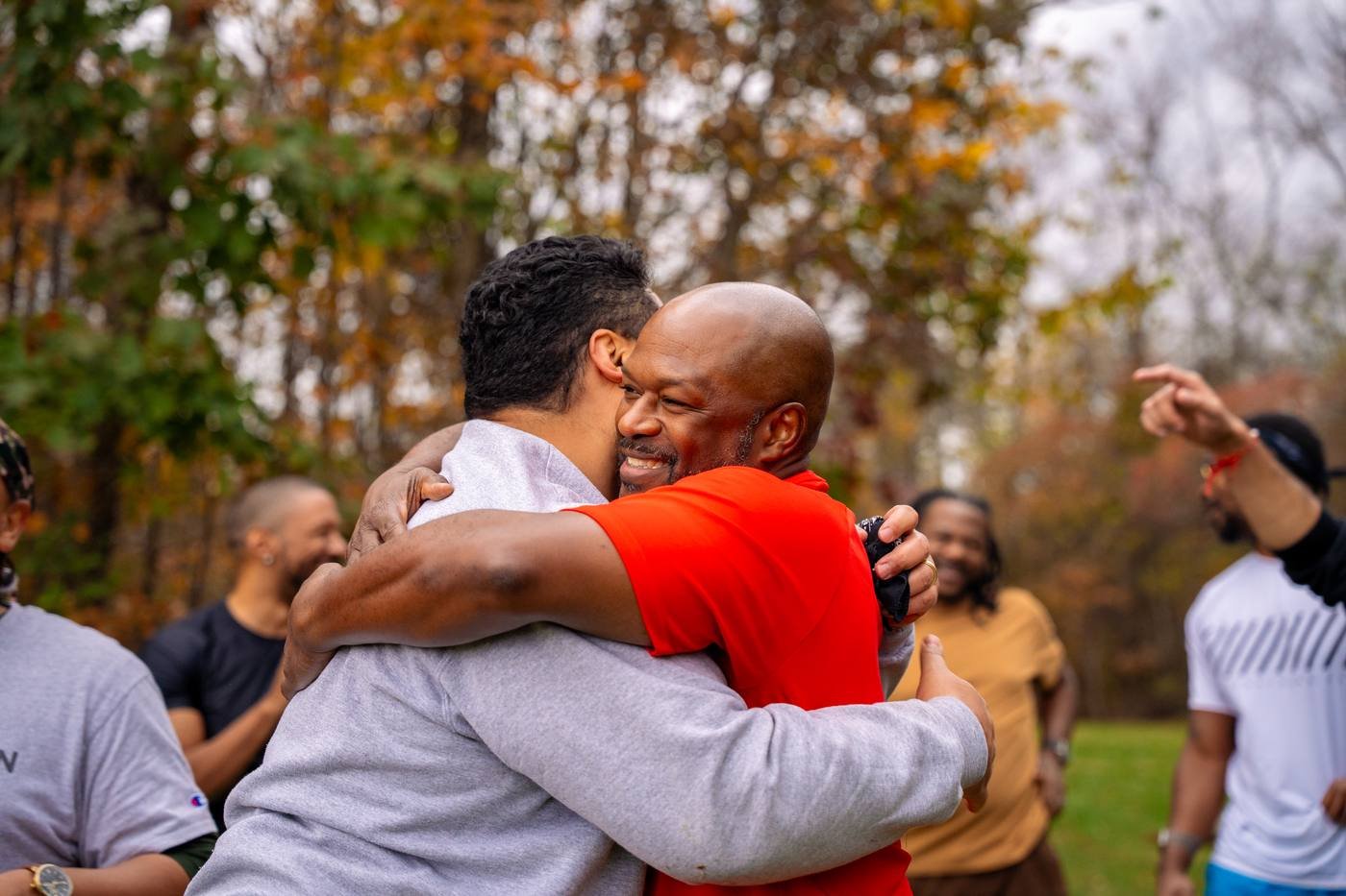 Two men in a full embrace