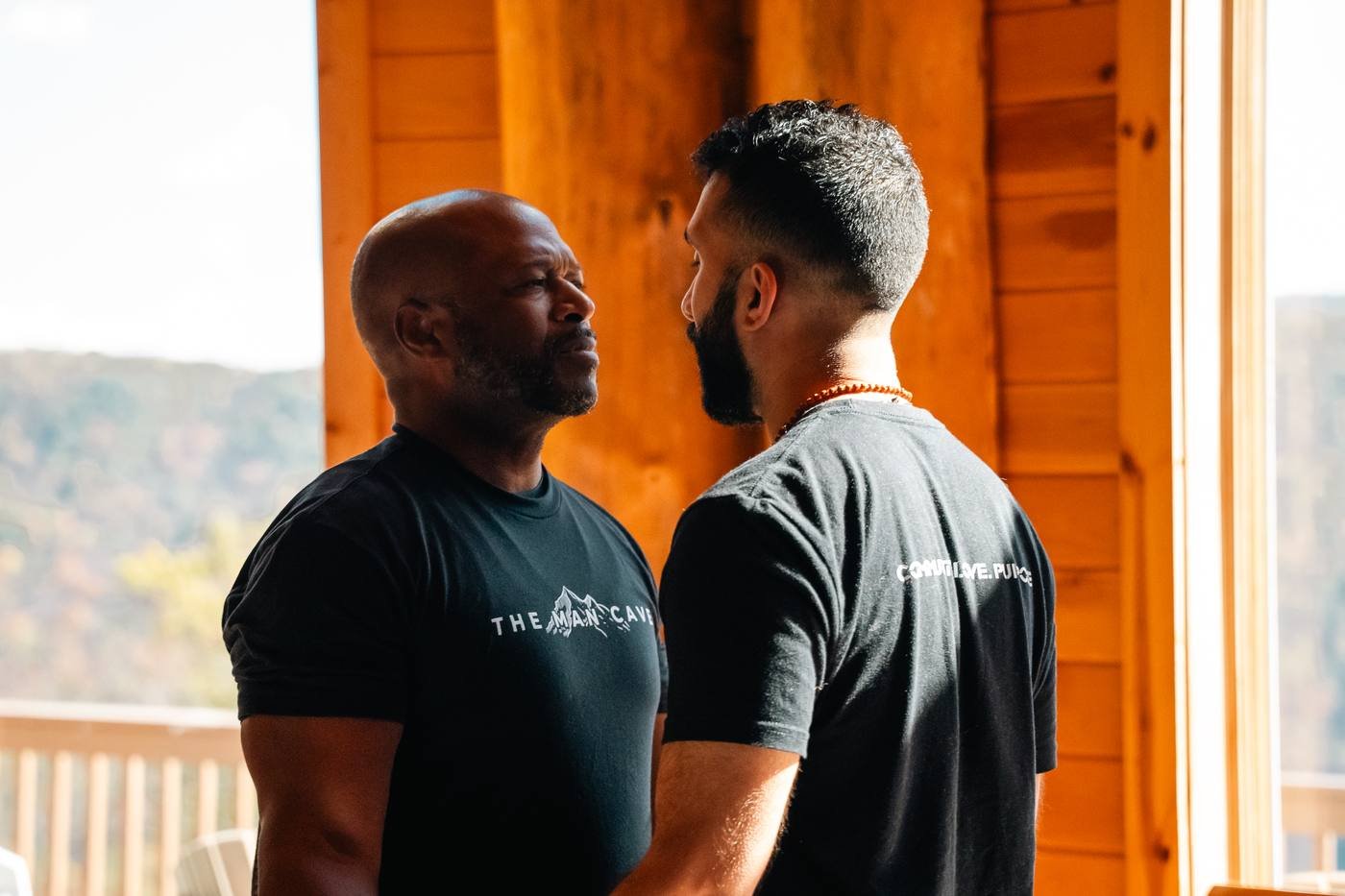 Two men standing face to face in a cabin